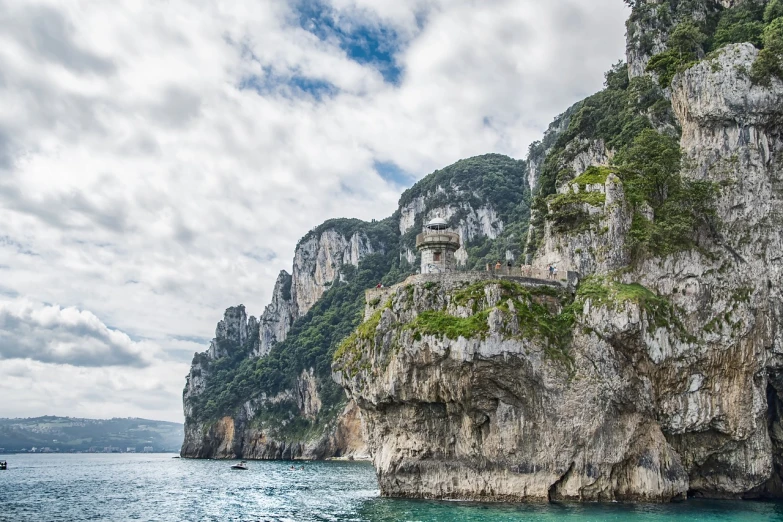 a couple of boats that are in the water, a detailed matte painting, by Richard Carline, shutterstock, renaissance, capri coast, overcast, сastle on the rock, the photo was taken from a boat