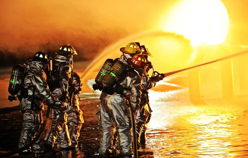 a group of firefighters standing next to a fire hydrant, by Scott M. Fischer, pixabay, fine art, luminous fire halo, with lots of fire coming from it, military photography, houses on fire