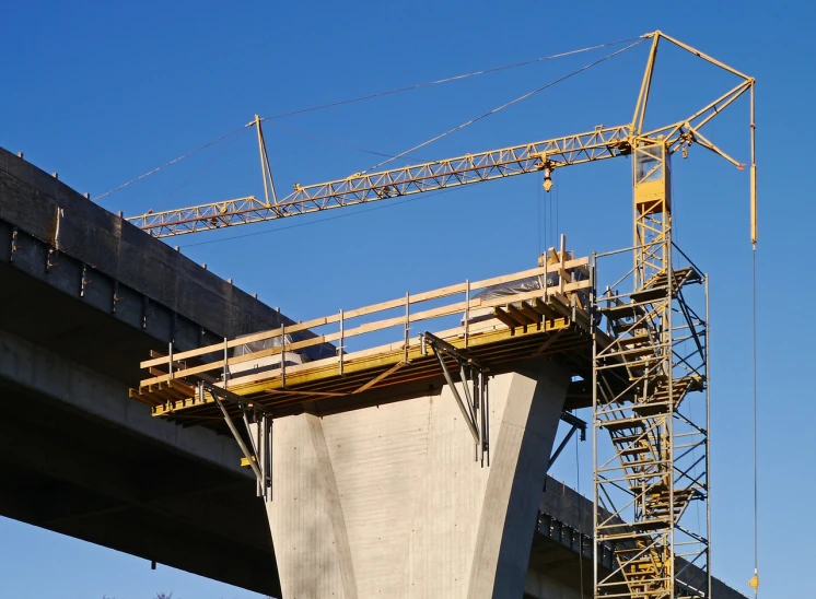 a large crane sitting on top of a bridge, flickr, large-scale, petite, concrete, profile shot