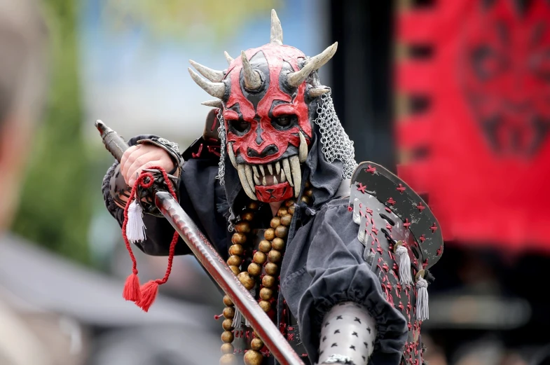 a close up of a person in a costume with a sword, by Robert Brackman, shutterstock, shin hanga, devils, gwar, japanese mascot, very sharp photo