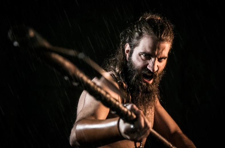a man with a long beard holding a baseball bat, by Mathias Kollros, shutterstock, hurufiyya, warrior fighting in a dark scene, production photo, the greek god, rain!!!!