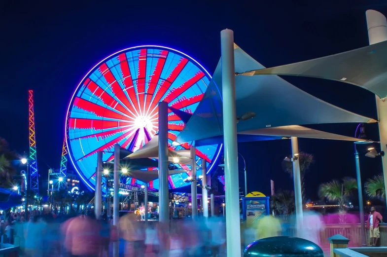 a large ferris wheel sitting in the middle of a park, a picture, hurufiyya, night on a summer miami beach, boardwalk, usa-sep 20, oceanside