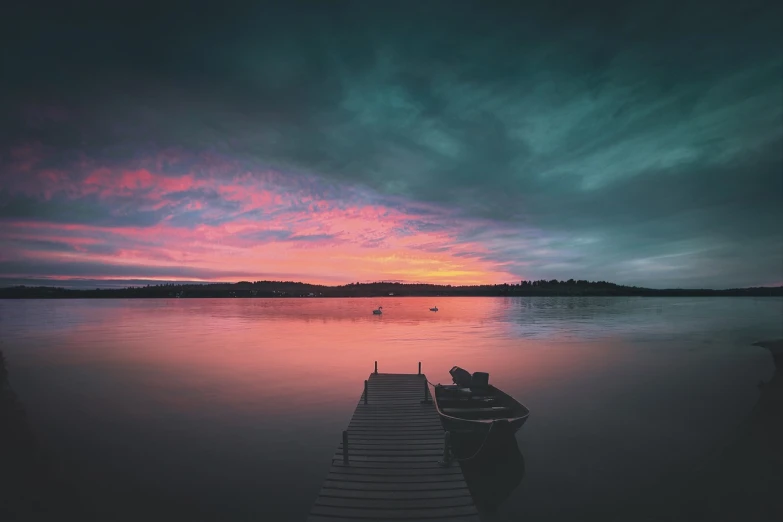 a boat sitting on top of a lake next to a dock, a picture, pexels contest winner, romanticism, colourful sky, mikko lagerstedt, redpink sunset, teal sky