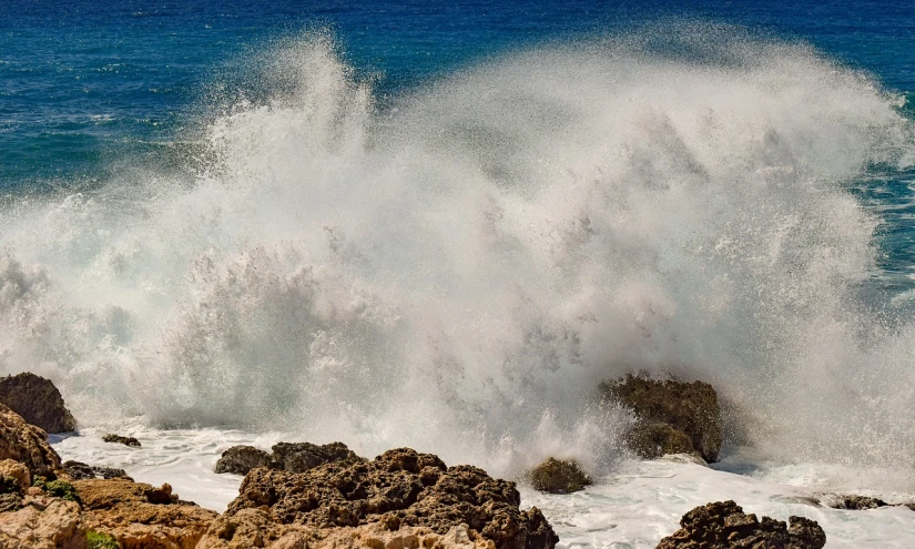 a man riding a surfboard on top of a wave, pexels, fine art, waves crashing at rocks, extreme panoramic, puerto rico, istockphoto