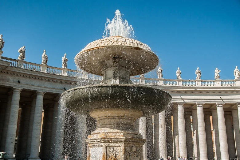 a fountain in front of a building with statues, by Cagnaccio di San Pietro, shutterstock, marble!! (eos 5ds r, colonnade, worship of the pope, hot summer day