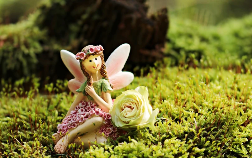 a fairy sitting on top of a lush green field, by Marie Angel, pixabay contest winner, cute decapodiformes, rose twining, mini model, happy friend