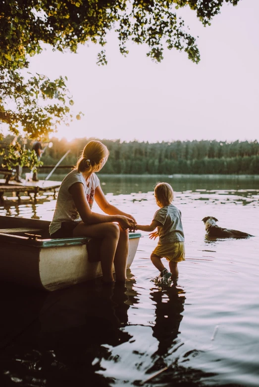 a woman and a child on a boat in the water, a picture, by Matt Cavotta, pexels, sitting at a pond, family dinner, 1 6 x 1 6, lofi