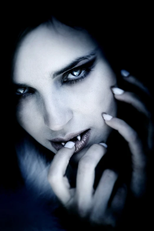 a close up of a person talking on a cell phone, a photo, inspired by Franz Sedlacek, flickr, gothic art, portrait of beautiful vampire, dominant wihte and blue colours, blank stare”