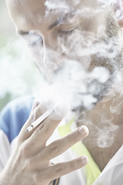 a close up of a person smoking a cigarette, a picture, by Jakob Gauermann, shutterstock, australian, 30 year old man, 2506921471, person in foreground