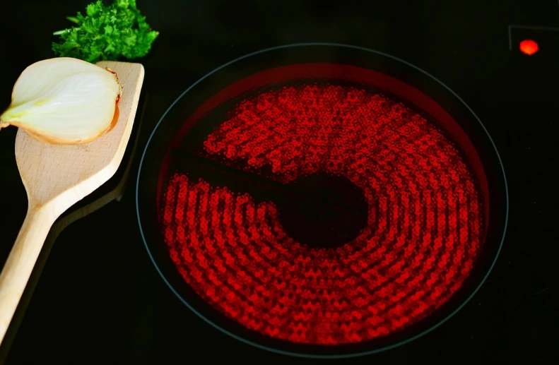 a wooden spoon sitting on top of a stove top, a hologram, by Aleksander Gierymski, kinetic pointillism, red leds, professional product photo, plate of borscht, circular