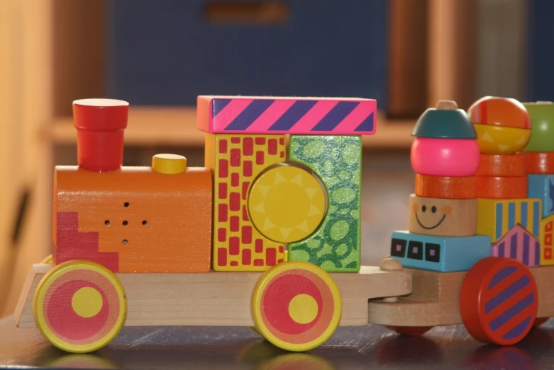 a close up of a toy train on a table, inspired by Okuda Gensō, toyism, blippi, a wooden, blocky, high light on the left