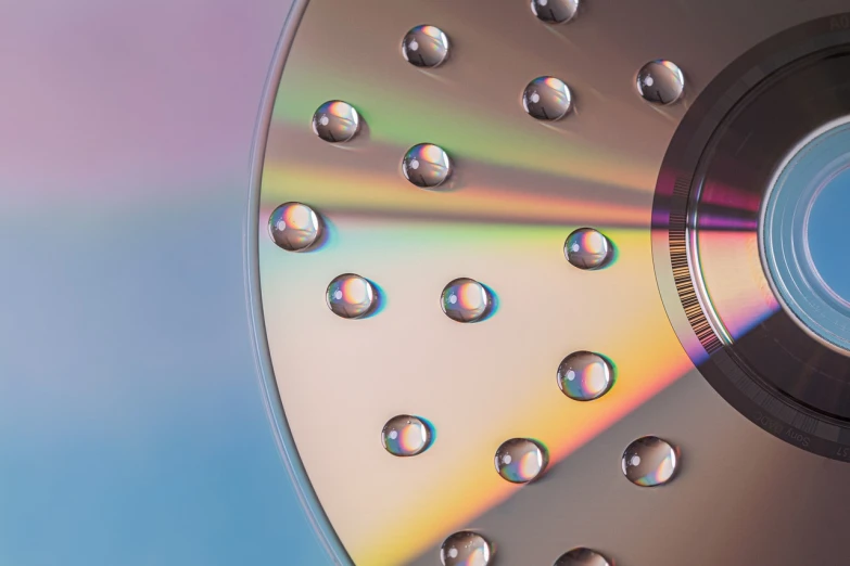 a close up of a disc with bubbles on it, a macro photograph, holography, high detail product photo, hyper photorealistic raytracing, hdd, high res photo