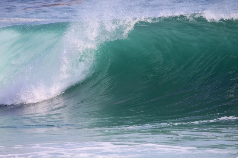 a man riding a wave on top of a surfboard, a picture, by Charles Ellison, shutterstock, tones of blue and green, glistening seafoam, curves!!, southern california