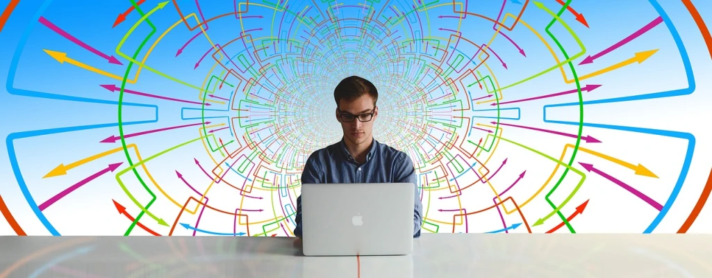 a man sitting in front of a laptop computer, pexels, computer art, fractals in the background, computer network, man with glasses, in the center of the image