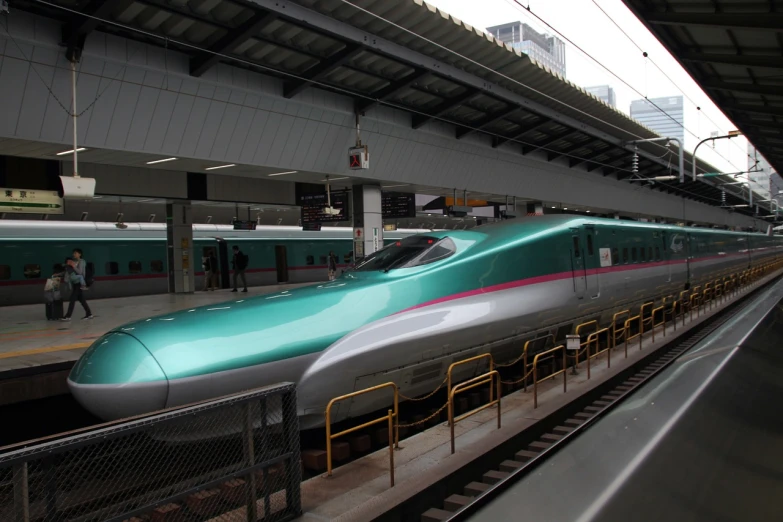 a green bullet train pulling into a train station, a picture, by Yanagawa Nobusada, flickr, teal and pink, shiny silver, very elegant & complex, it is very huge