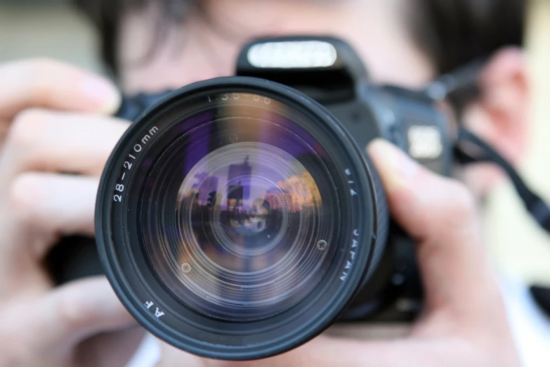 a close up of a person holding a camera, a picture, lens blur, pointing at the camera, headshot profile picture, uhd photography