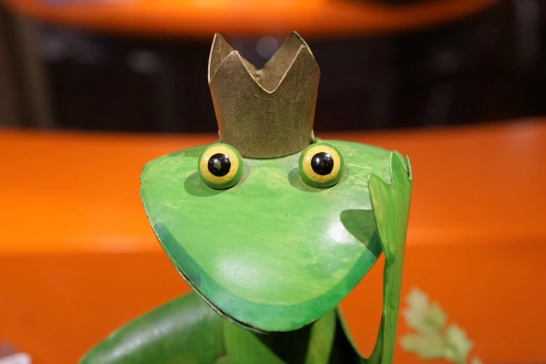 a green frog with a crown on its head, a surrealist sculpture, by Maeda Masao, pexels, visual art, 😃😀😄☺🙃😉😗, metal art, kid, cut