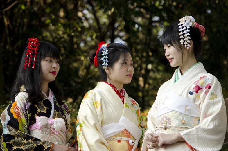 a group of women standing next to each other, inspired by Uemura Shōen, shutterstock, candid photography, panoramic view of girl, sideways glance, traditional costume