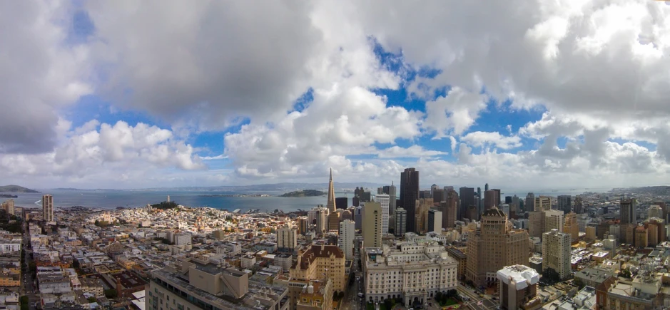 a view of a city from the top of a building, by Dan Scott, gopro photo, sf, cloud, panoramic widescreen view