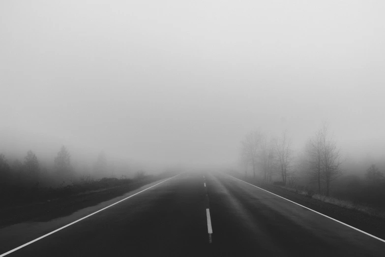 a black and white photo of a foggy road, unsplash, postminimalism, hq 4k phone wallpaper, highway to hell, jovana rikalo, volumetric fog