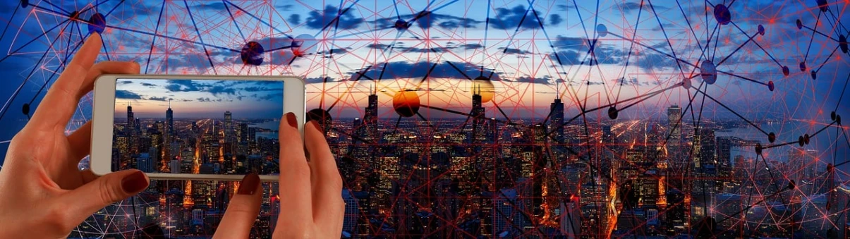 a person holding up a smart phone with a city in the background, digital art, by Jon Coffelt, pixabay contest winner, futurism, montage of grid shapes, string theory, sun down, giantess art