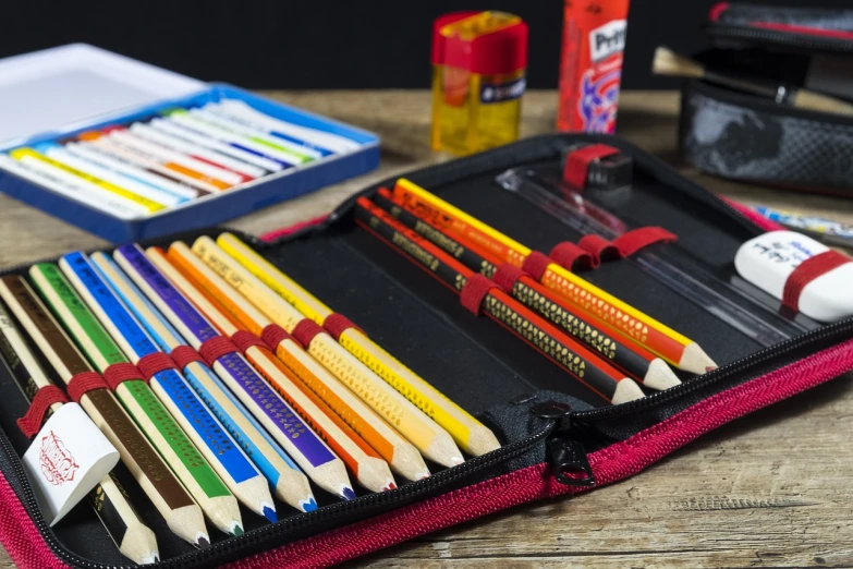 a pencil case filled with lots of different colored pencils, by Tom Wänerstrand, product photography 4 k, black and yellow and red scheme, complete scene, detailed surroundings