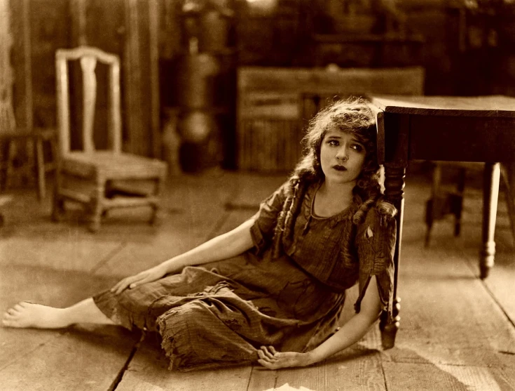 a black and white photo of a little girl sitting on the floor, by Joseph Kleitsch, flickr, art nouveau, dramatic movie still, colleen moore 2 2 years old, square, stained”