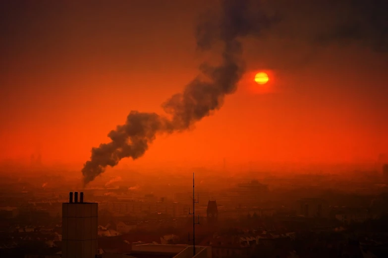 a red sky with smoke coming out of it, a picture, by Stefan Gierowski, shutterstock, polluted, the sun is setting, silicon and carbon, taken in 1 9 9 7