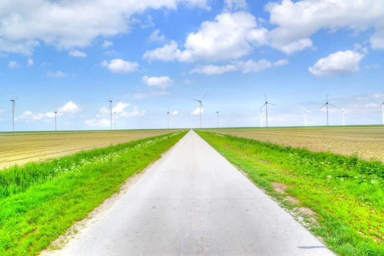 a country road with wind turbines in the distance, minimalism, high definition photo, high res photo