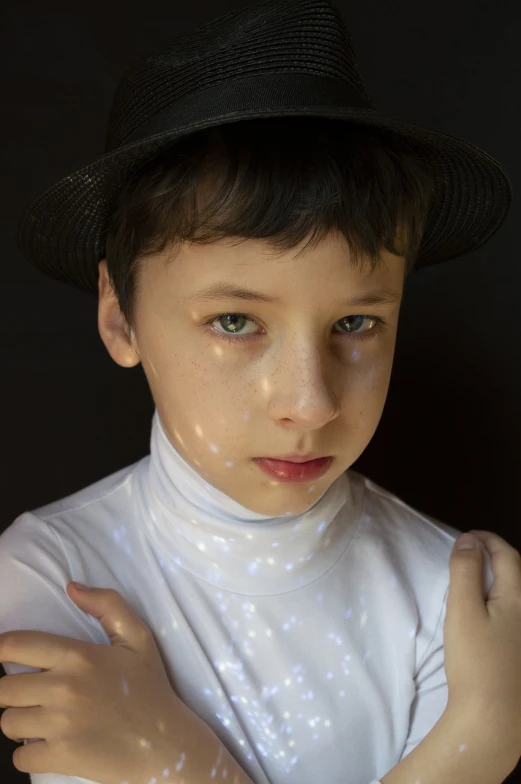 a close up of a child wearing a hat, holography, twink, porcelain highlighted skin, light over boy, high angle closeup portrait