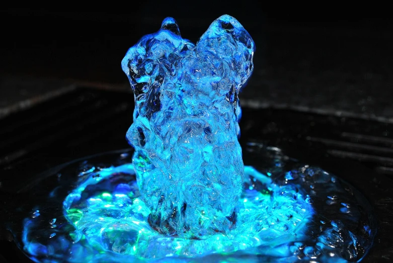 a close up of a water fountain with blue lights, a hologram, pexels, process art, water bear, istockphoto, ice mage, body made of glass