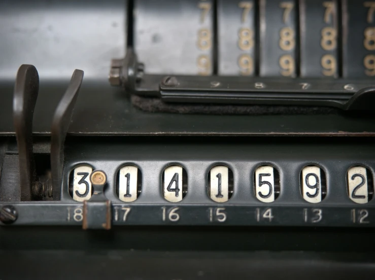 a close up of a machine with numbers on it, unsplash, les automatistes, historical image, brown scales, the price of ncr, algebra