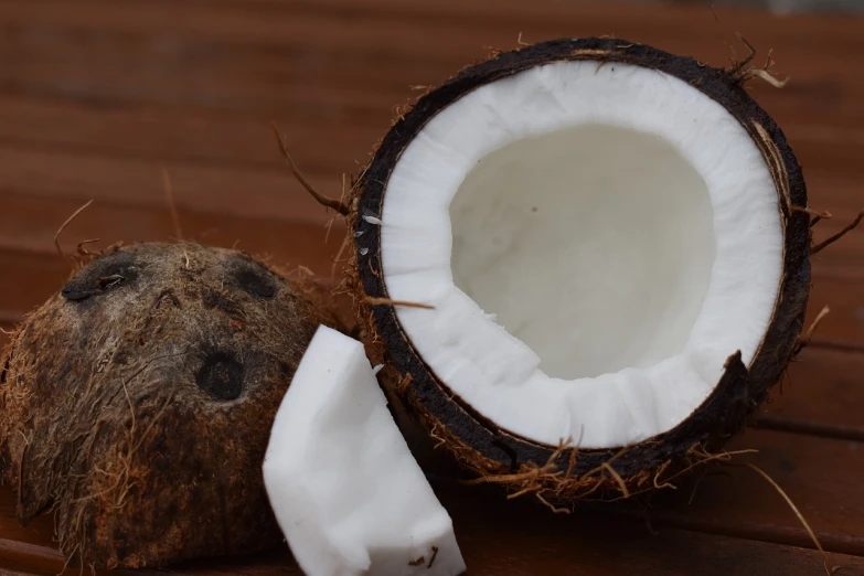 a coconut sitting on top of a wooden table, by Sam Dillemans, pixabay, hurufiyya, cocaine, white muzzle and underside, yin yang, pattern