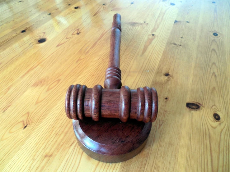 a wooden gaven sitting on top of a wooden table, a picture, pexels, gavel, extremely detailed frontal angle, indoor, version 3