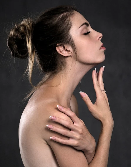 a woman with her hands on her chest, by Eugeniusz Zak, shutterstock, elegant profile pose, photoshoot for skincare brand, very long neck, hands reaching for her