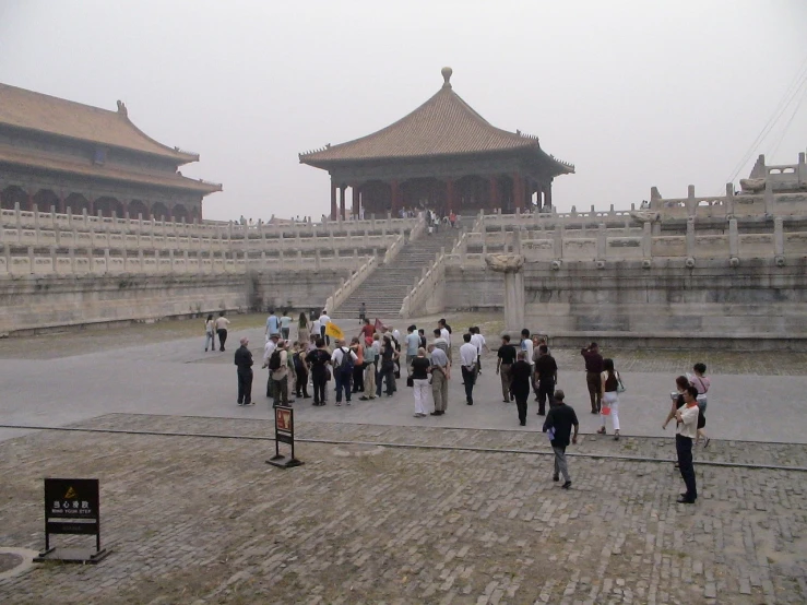 a group of people standing in front of a building, by Wang Yi, flickr, elegant walkways between towers, some dust in the air, floor b2, ancient”