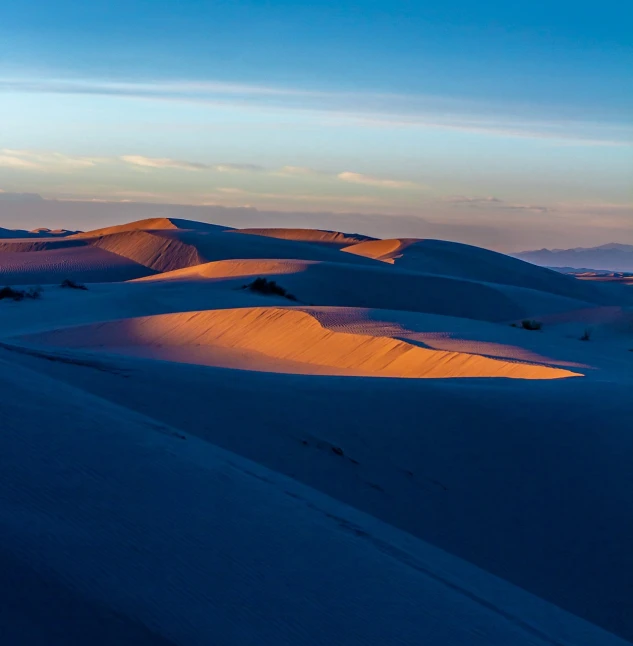 a group of sand dunes sitting in the middle of a desert, by Juan O'Gorman, art deco, golden hour in pismo california, red and blue back light, shadows. asian landscape, violet and yellow sunset