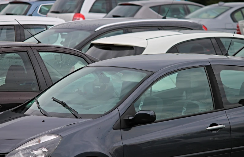 a parking lot filled with lots of parked cars, by John Henderson, shutterstock, les automatistes, depth detail, onlookers, viewed through the cars window, vertical orientation