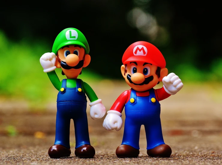 a couple of action figures standing next to each other, a picture, inspired by Luigi Kasimir, pexels, video game icon, cute boys, super detailed picture, green blue red colors