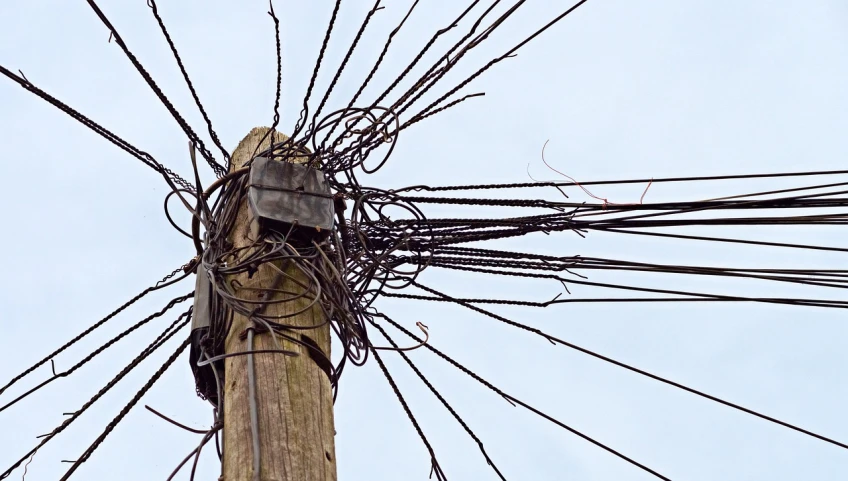 a telephone pole with a bunch of wires attached to it, inspired by Peter Gric, spider nest, television head, zoomed in, the wicker man