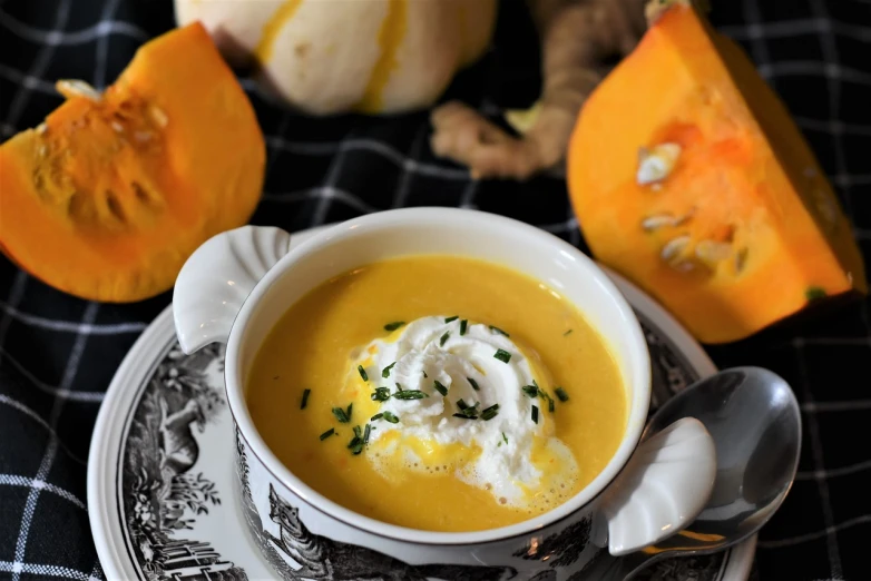 a bowl of soup sitting on top of a plate, inspired by Géza Dósa, pumpkins, ginger, cutecore, white