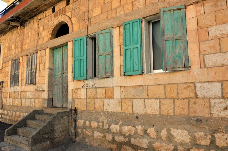 an old stone building with green shutters, by Edward Ben Avram, shutterstock, dau-al-set, local close up, 19th-century, deserted, colorful house