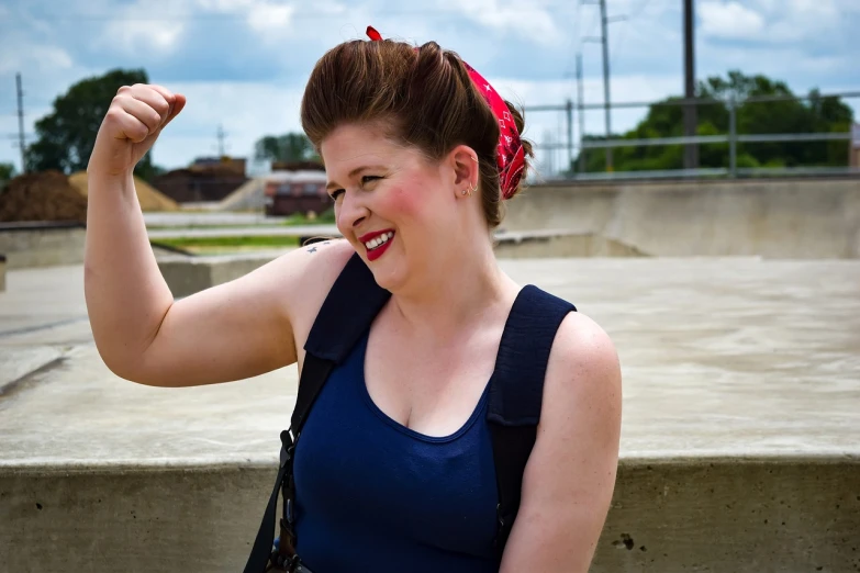 a woman with her arm in the air, a portrait, by Kristin Nelson, flickr, rockabilly hair, bbwchan, on a bridge, girl with warship parts