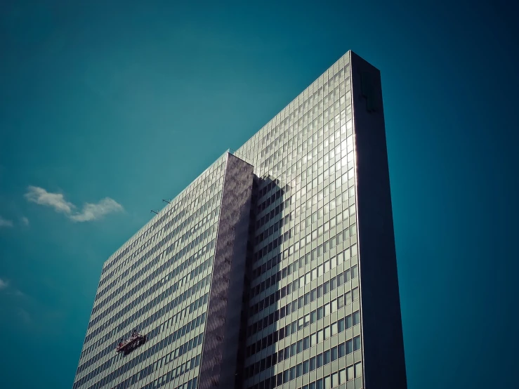 a tall building with a blue sky in the background, a photo, by Matthias Weischer, retro effect, capital plaza, manifestation, ivan shishk