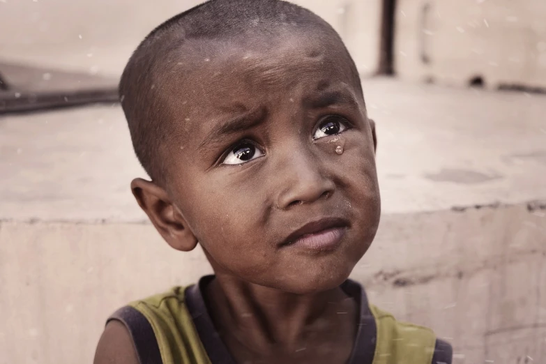 a young boy with a sad look on his face, a picture, by Joze Ciuha, hurufiyya, well edited, giga chad crying, sri lanka, short brown hair and large eyes