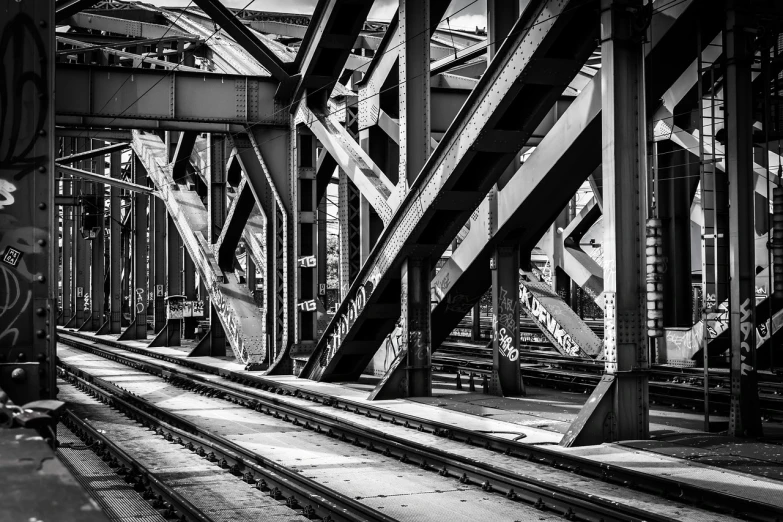 a black and white photo of a train station, precisionism, hell gate, steel, 🧒 📸 🎨, bridges