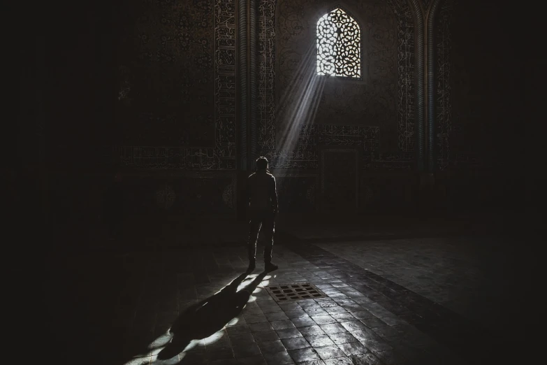 a man standing in a dimly lit room, by Kamāl ud-Dīn Behzād, unsplash contest winner, arabesque, holy place, backlight photo sample, by emmanuel lubezki, samarkand