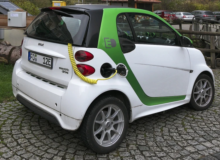 a smart car with an electric charger plugged into it, by Oskar Lüthy, pixabay, renaissance, green skinned, very very very epic, car on sale, nicely detailed