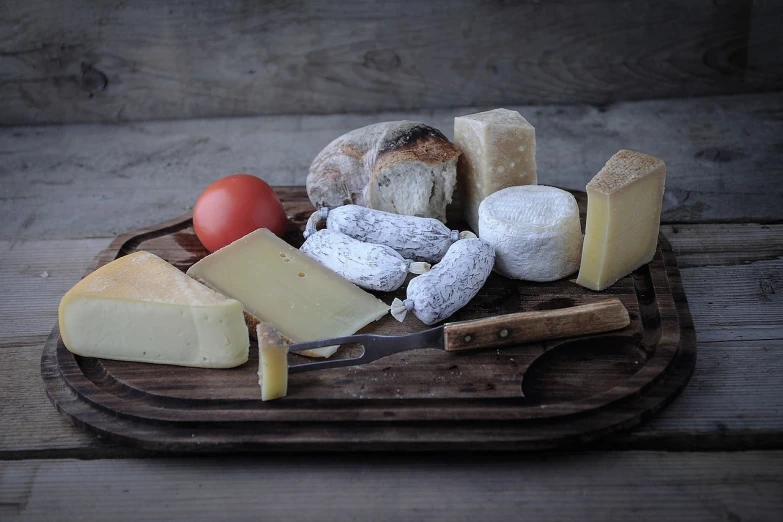 a wooden cutting board topped with different types of cheese, a still life, assemblage, foodphoto, traditional corsican, crisp photo