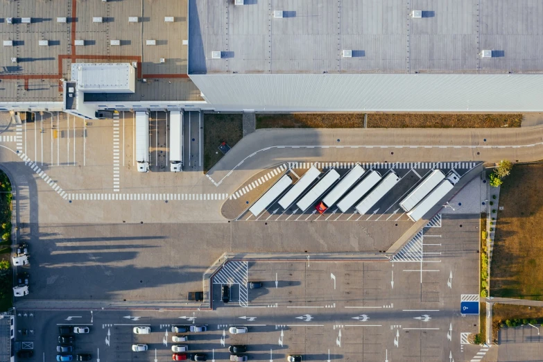 an aerial view of a parking lot with trucks, pexels contest winner, bauhaus, warehouse, stock photo